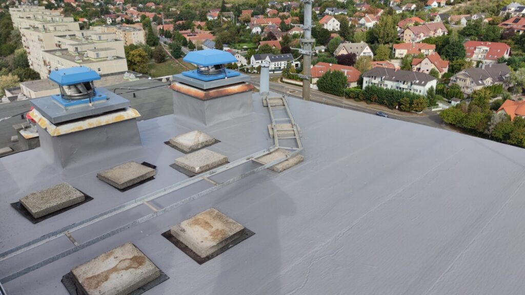 Flat roof waterproofing work viewed from above.