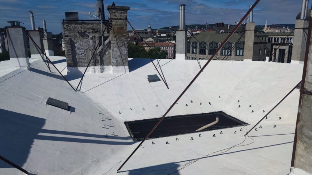 Flat roof waterproofing work viewed from above.
