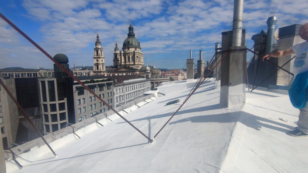 Flat roof waterproofing work viewed from above.