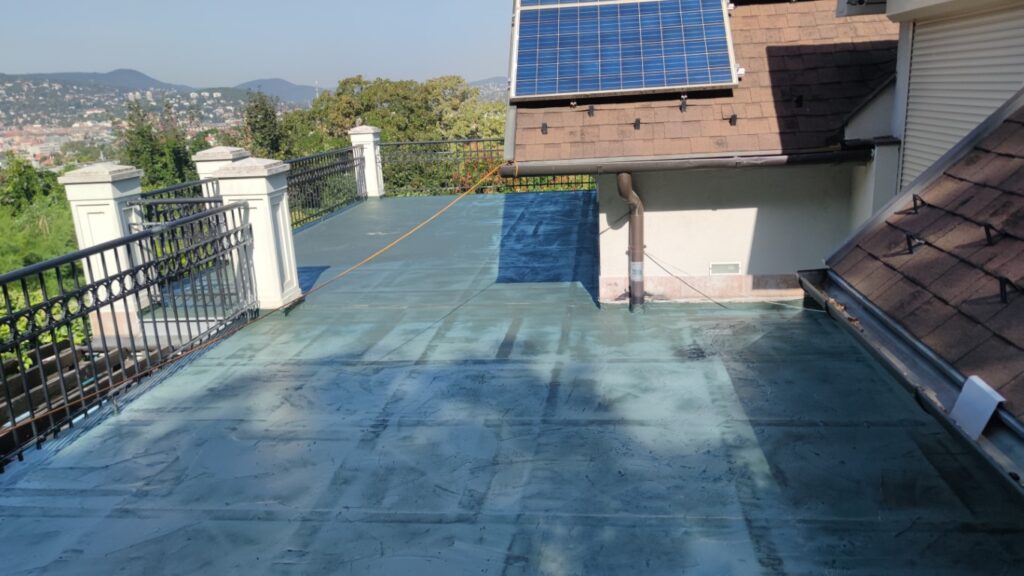 Flat roof waterproofing work viewed from above.