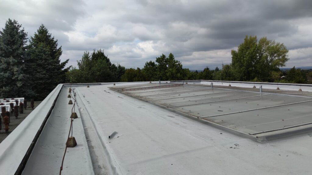 Flat roof waterproofing work viewed from above.