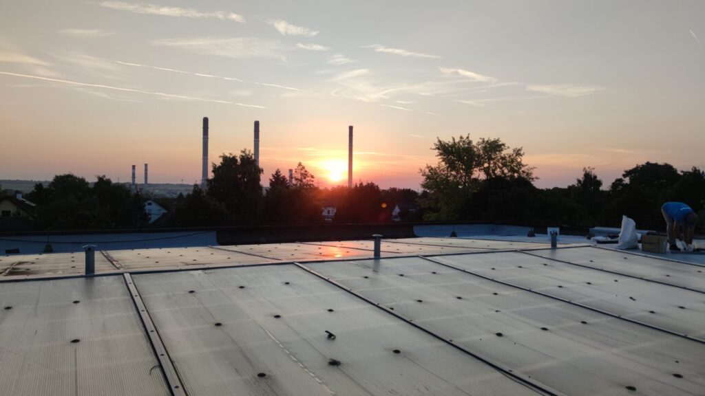 Flat roof waterproofing work viewed from above.