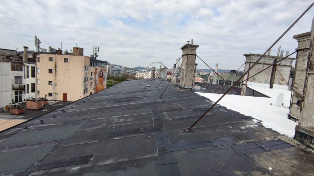 Flat roof waterproofing work viewed from above.