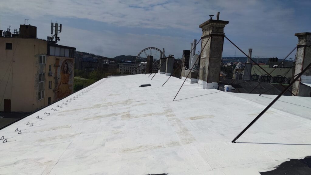 Flat roof waterproofing work viewed from above.
