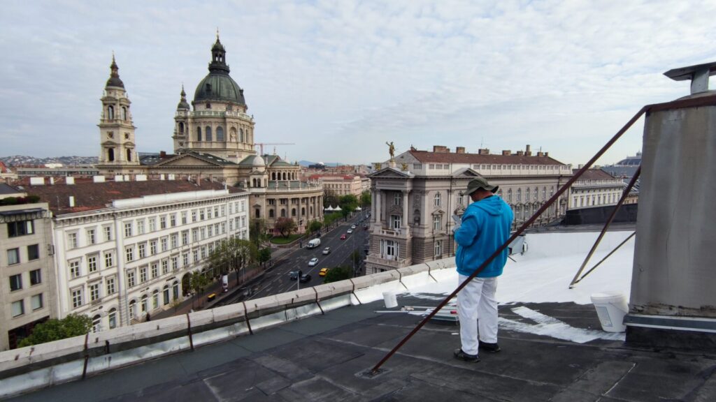 Flat roof waterproofing work viewed from above.