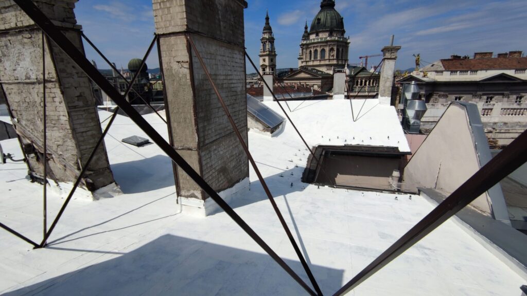 Flat roof waterproofing work viewed from above.