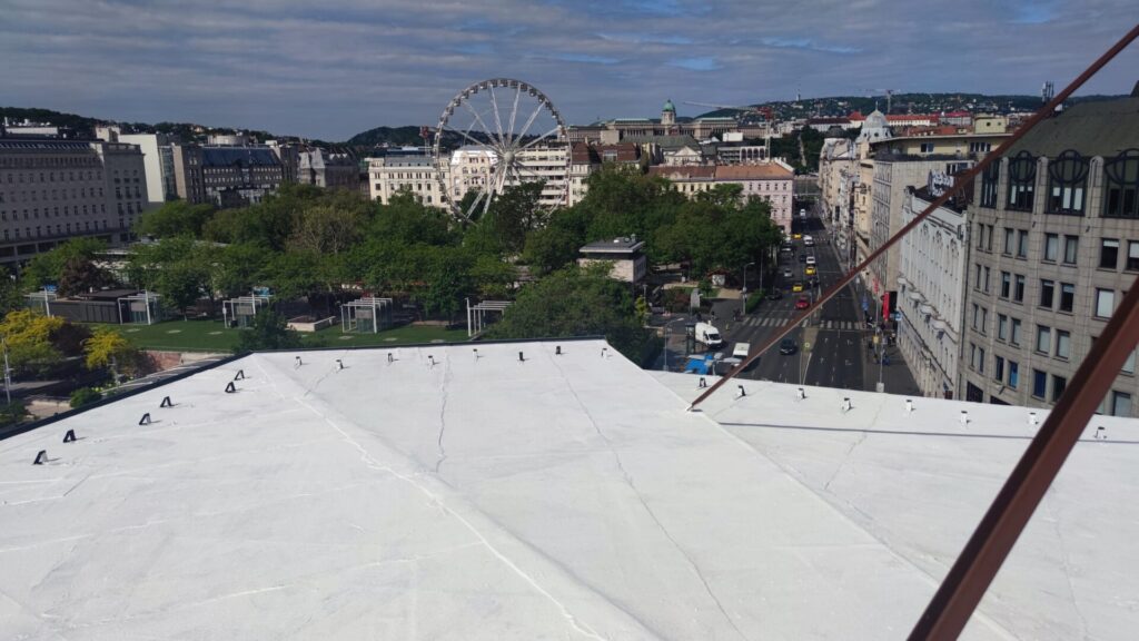 Flat roof waterproofing work viewed from above.