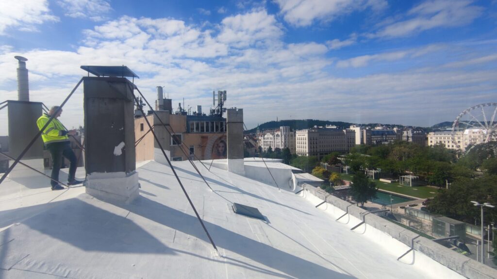 Flat roof waterproofing work viewed from above.