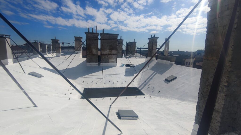 Flat roof waterproofing work viewed from above.