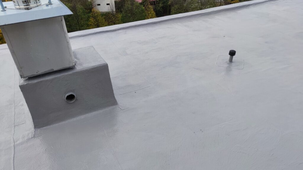 Flat roof waterproofing work viewed from above.