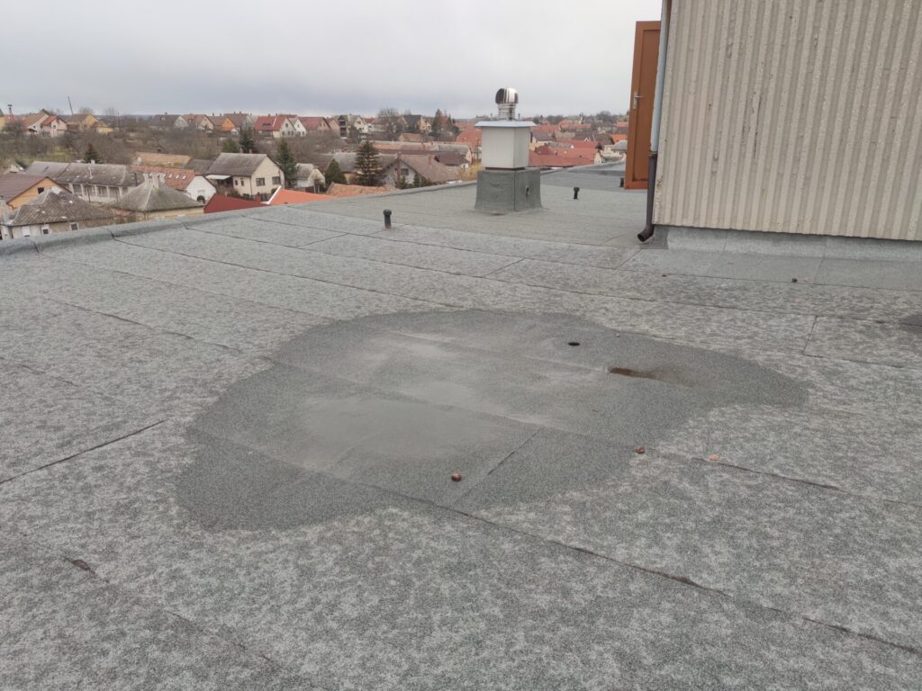 Flat roof waterproofing work viewed from above.