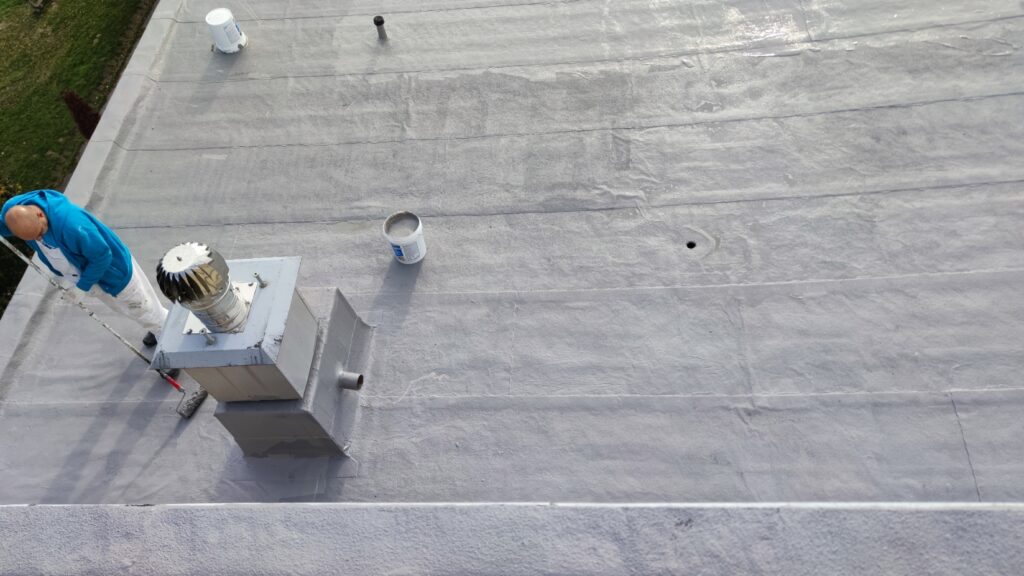 Flat roof waterproofing work viewed from above.