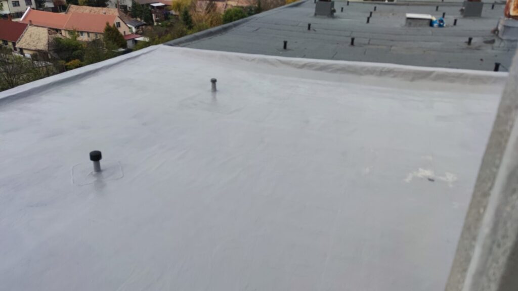 Flat roof waterproofing work viewed from above.