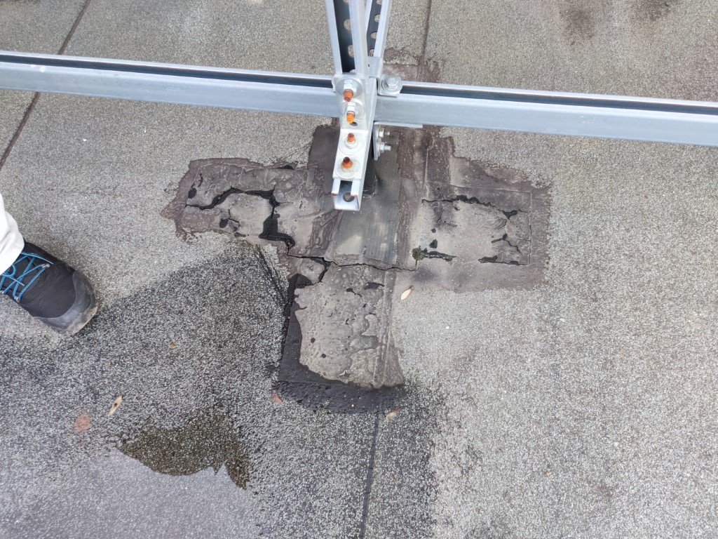 Flat roof waterproofing work viewed from above.