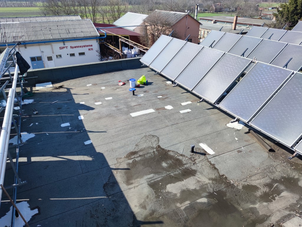 Flat roof waterproofing work viewed from above.