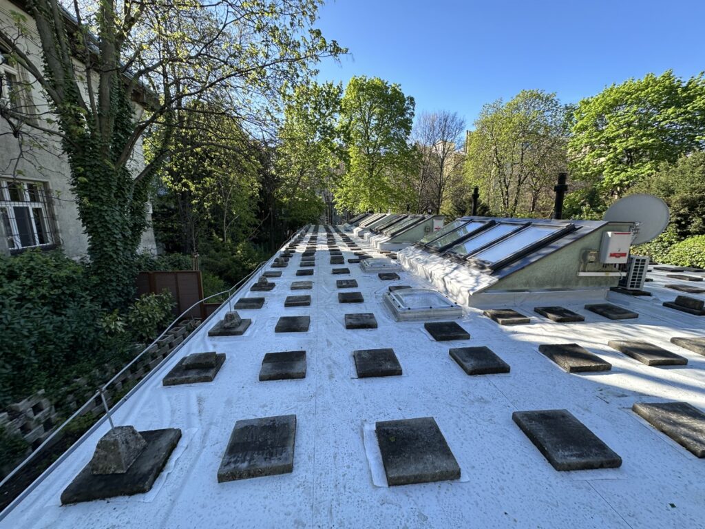 Flat roof waterproofing work viewed from above.