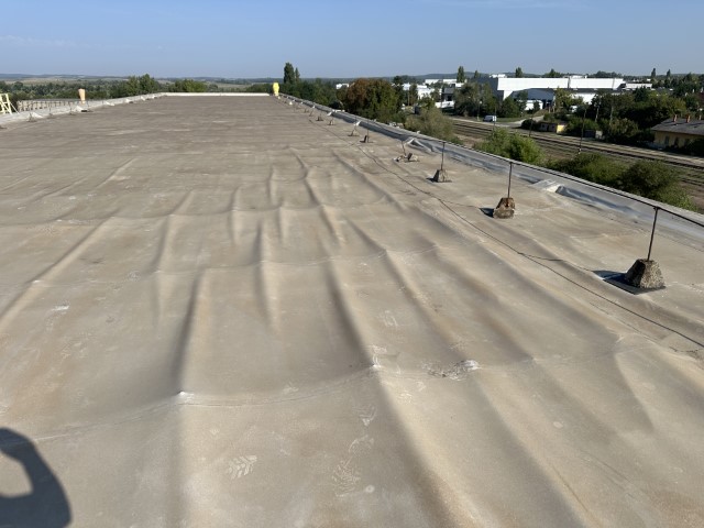 Flat roof waterproofing work viewed from above.
