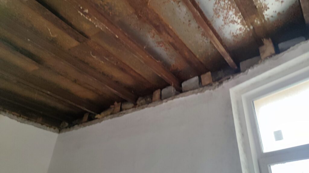 Flat roof waterproofing work viewed from above.