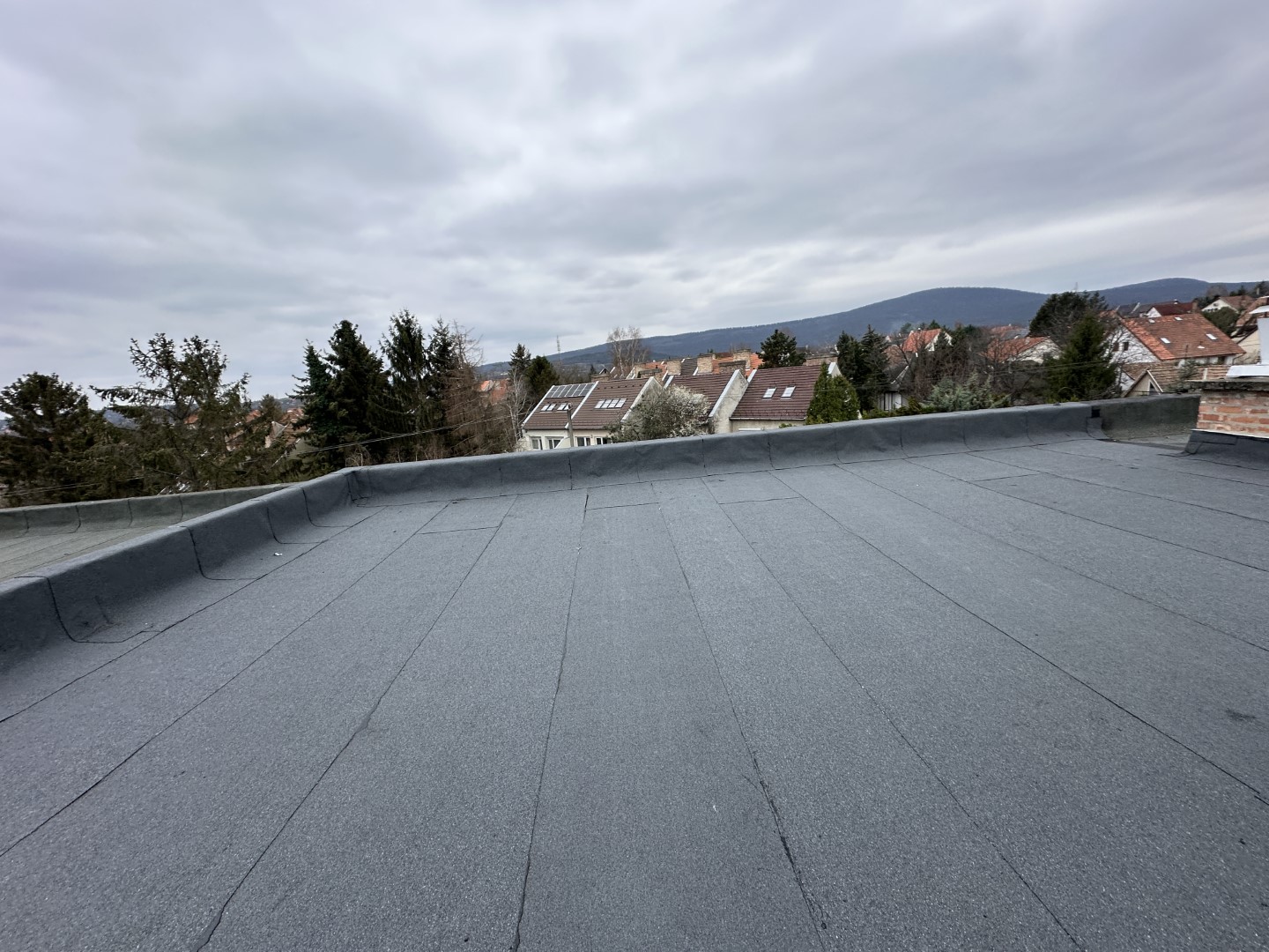 Flat roof waterproofing work viewed from above.