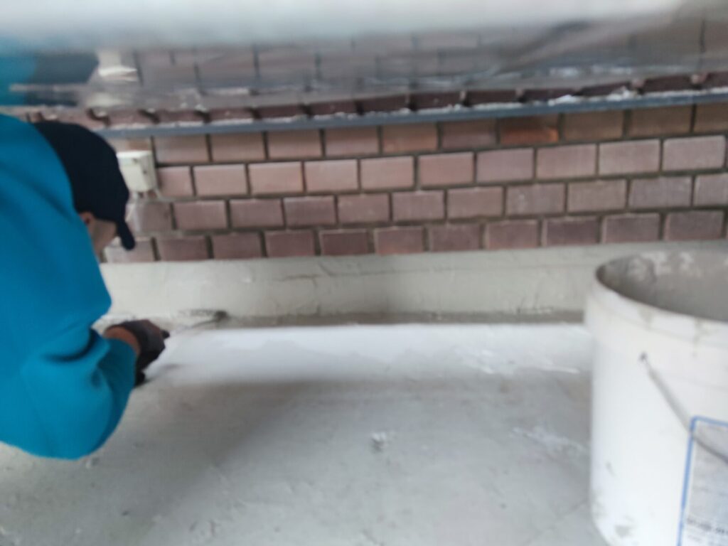 Flat roof waterproofing work viewed from above.