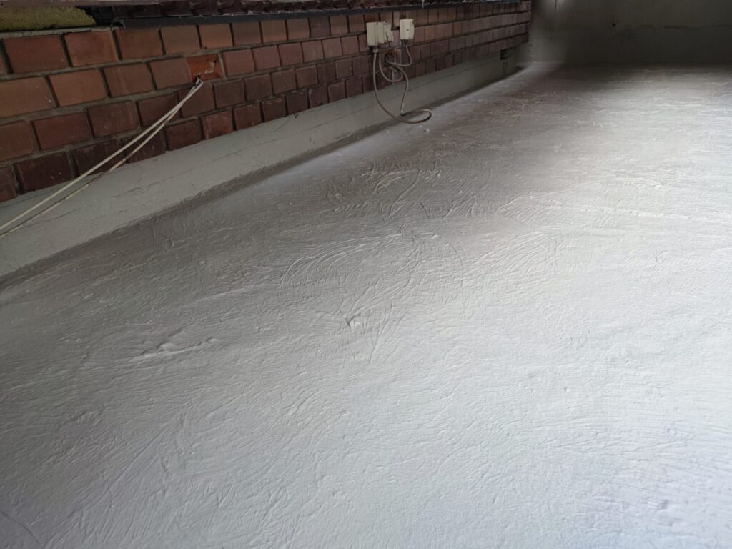 Flat roof waterproofing work viewed from above.