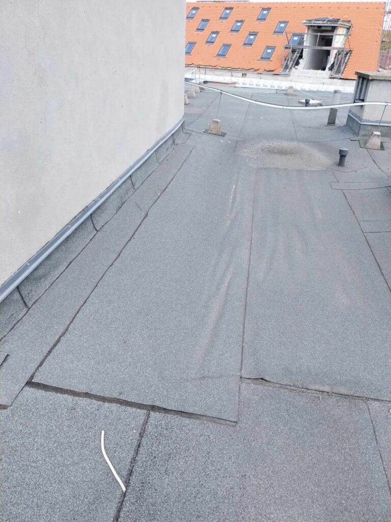 Flat roof waterproofing work viewed from above.