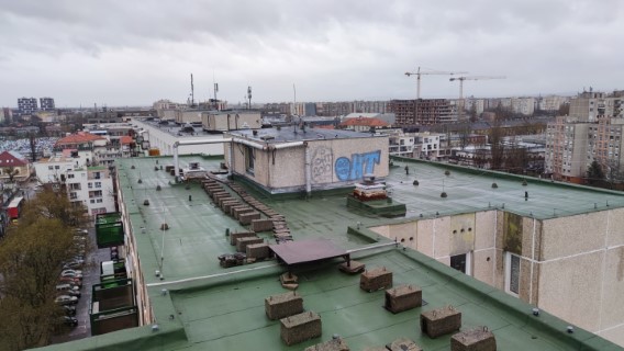 Flat roof waterproofing work viewed from above.