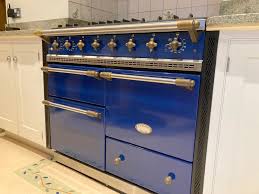 Blue paneled cabinet with ornate gold-colored hardware.