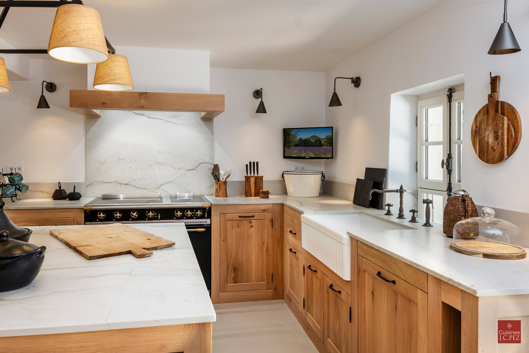 Bright pale kitchen with wood island.