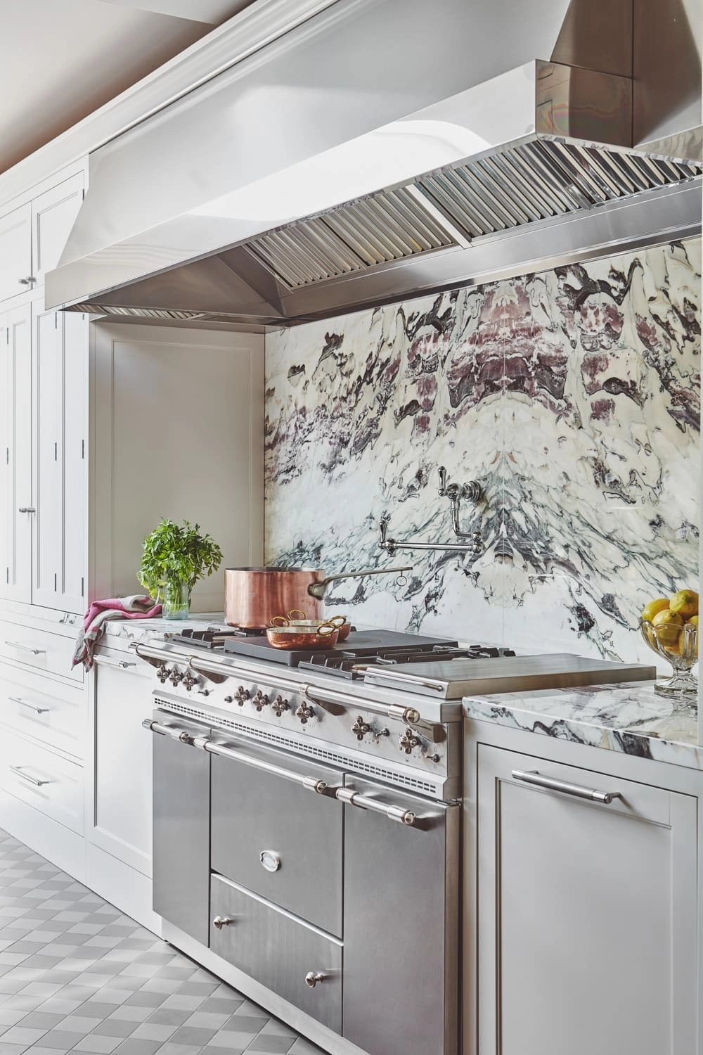 Compact white kitchen with dark range.