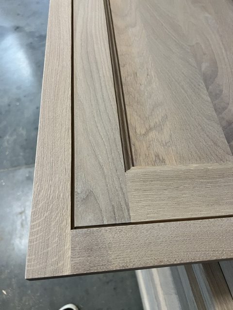 Gray wood-grain panel with white trim; detail src-0178