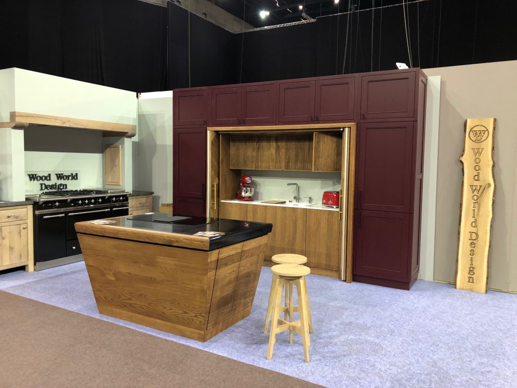 Burgundy wall cabinetry, wood island and tall wood display panel.