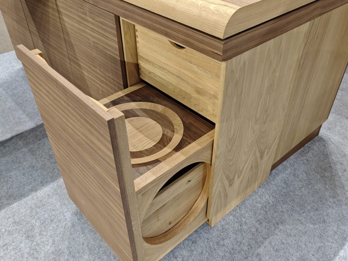 Close-up of rounded wood corner with curved open shelf.