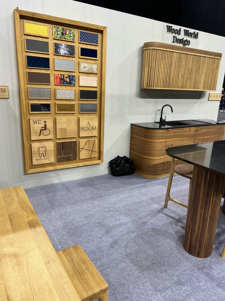 Display wall with framed cabinet fronts and wood counter samples.