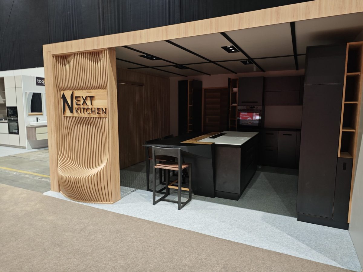 Long wood island photographed from the rear with open black drawers.