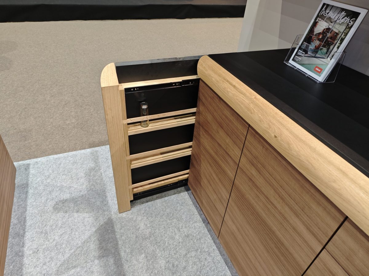 Open wood drawer bank with multiple shallow compartments.
