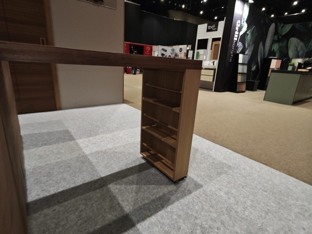Tall narrow wood cabinet or partition photographed from the side.