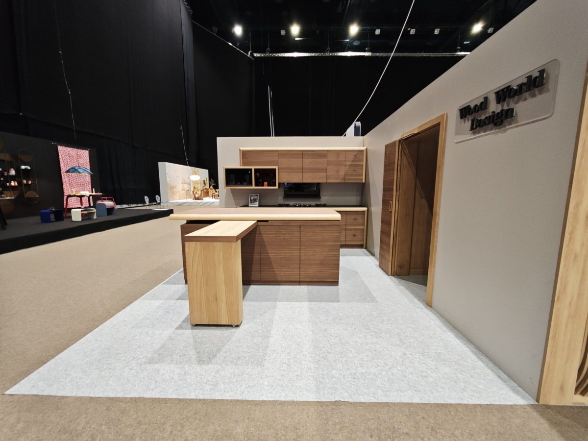 Wide exhibition view of a wood-and-black kitchen display.