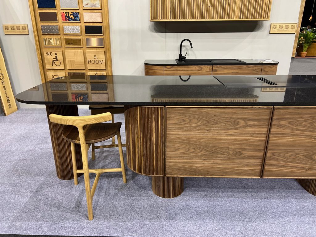 Wood counter and cabinet run with a chair in front.