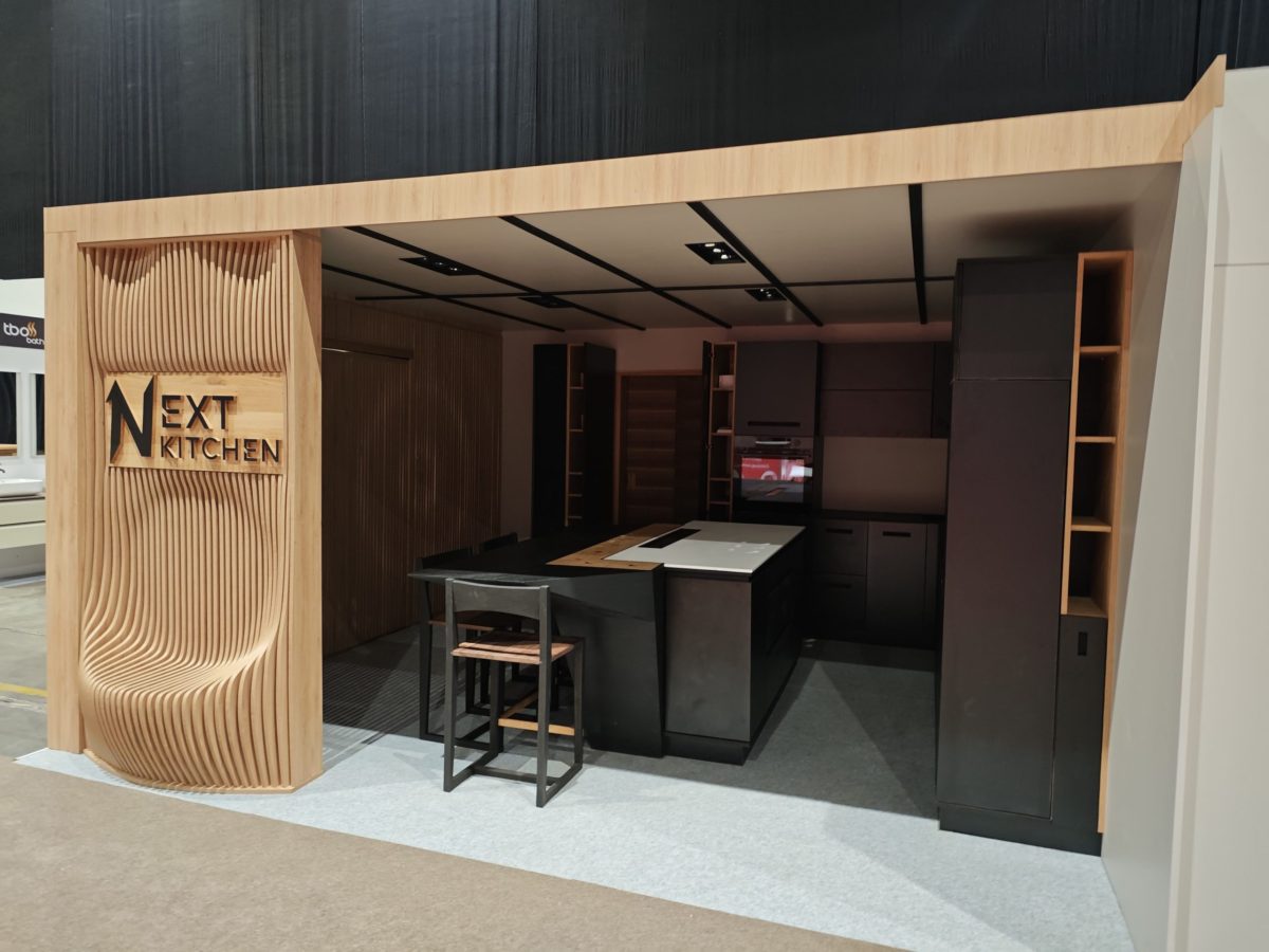 Wood display wall and compact island with black fronts.