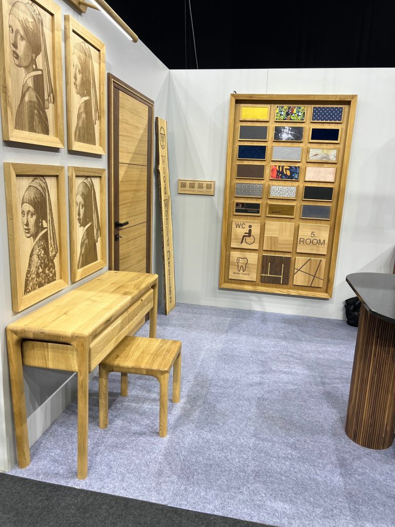 Wood panel sample wall with open shelving and a small table.