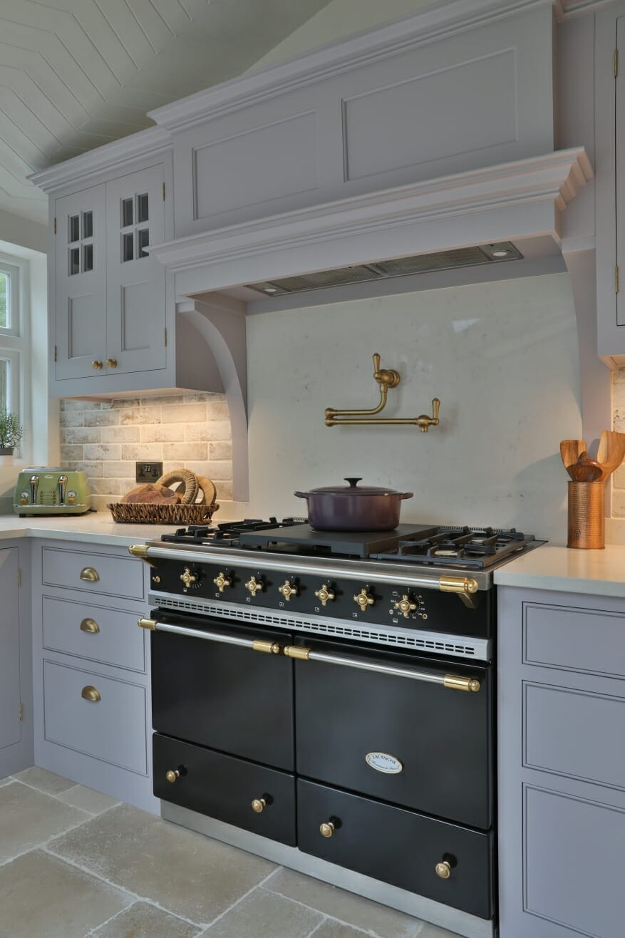 Galley kitchen with dark range and open shelf.