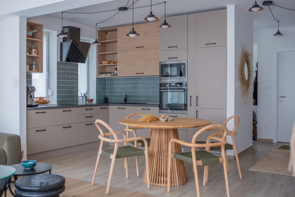 Light gray kitchen with round wood table and bentwood chairs.