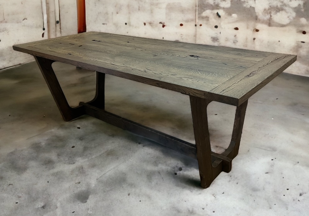 Gray-brown tabletop on dark angled trestle legs.