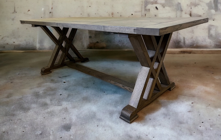 Gray tabletop supported by dark crossed trestles.
