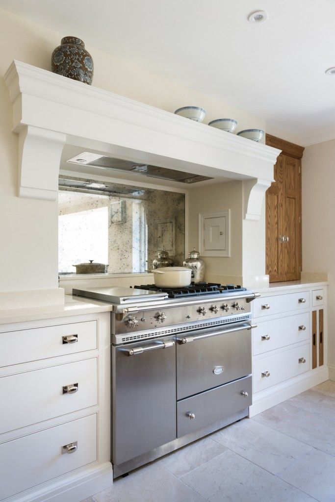 Green-and-white kitchen with white range.