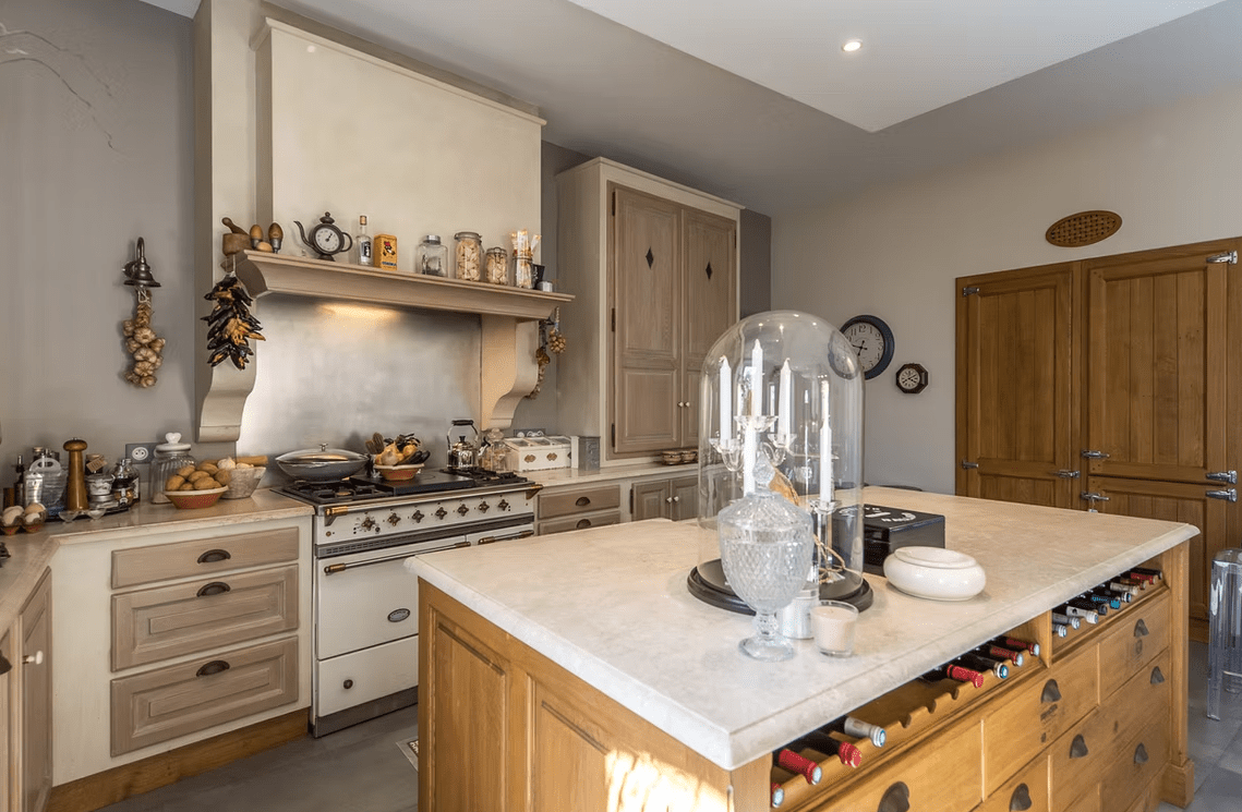 Light kitchen with dark red range.
