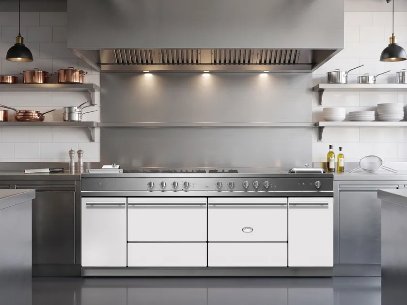 Light kitchen with pale cabinetry and range.