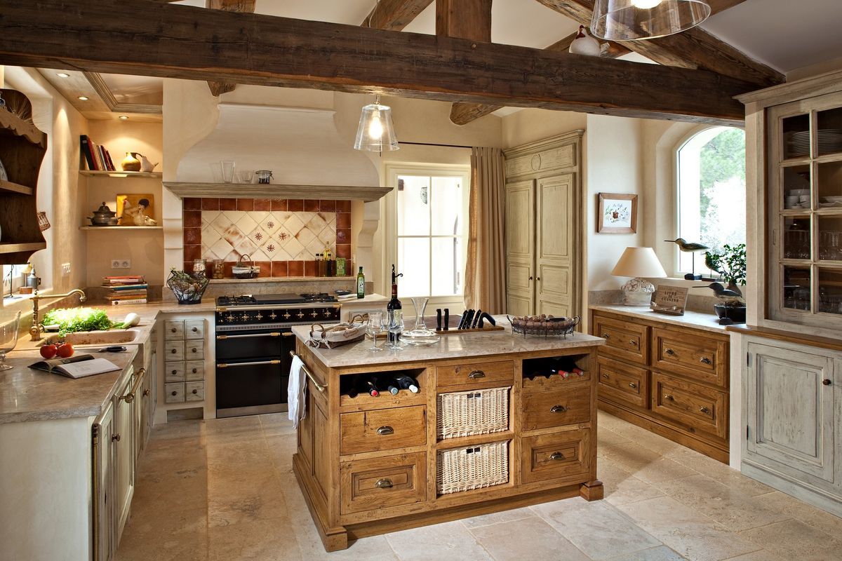 Light kitchen with pale island and patterned backsplash.