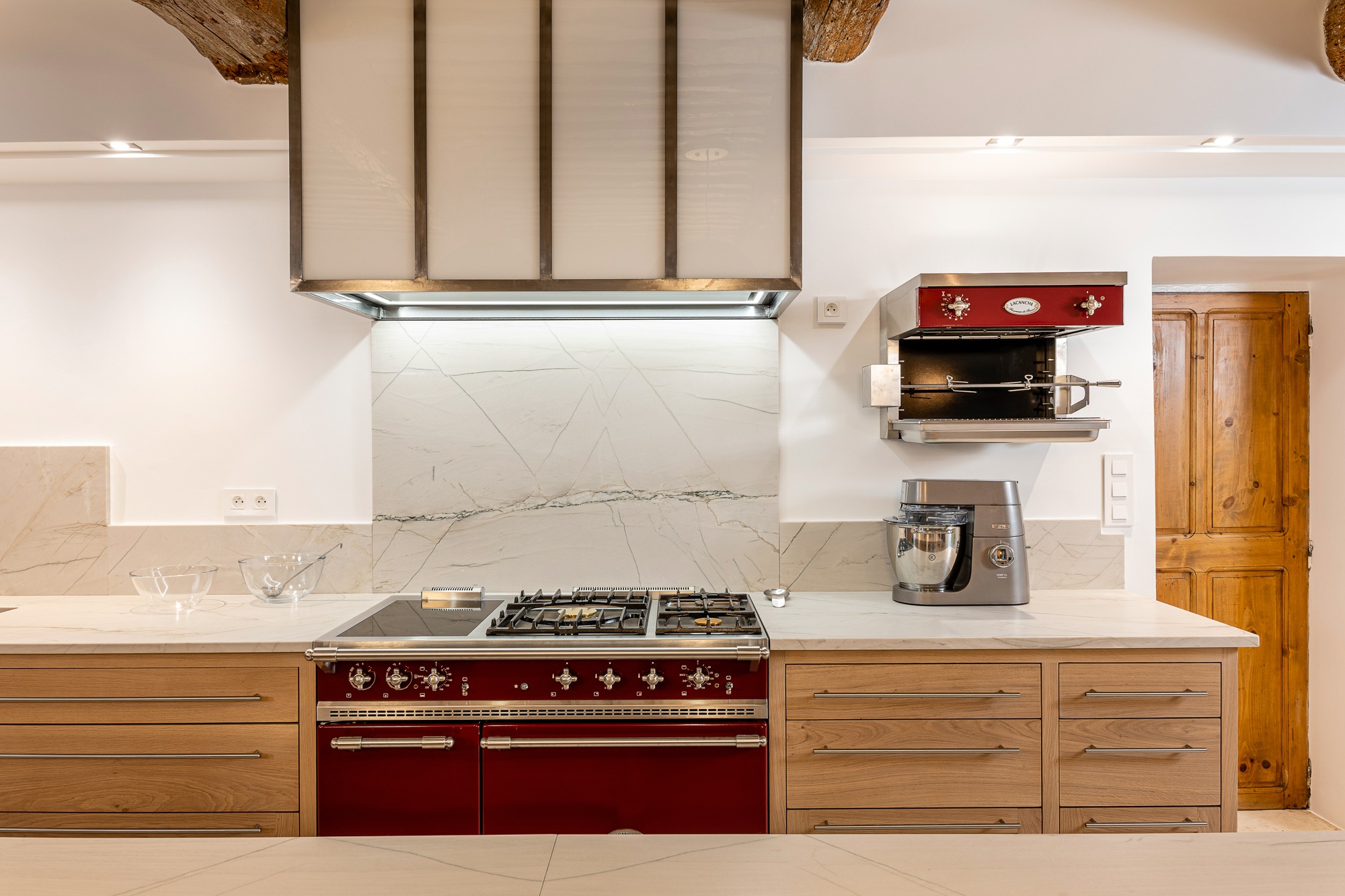 Light wood kitchen with glass-front cabinetry.
